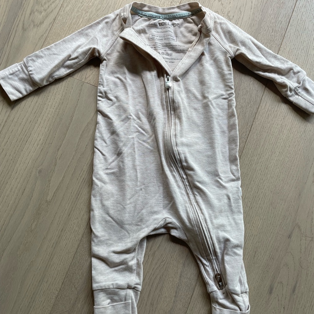 Lulu lollipop 3-6 month onsie on warm beige colour.